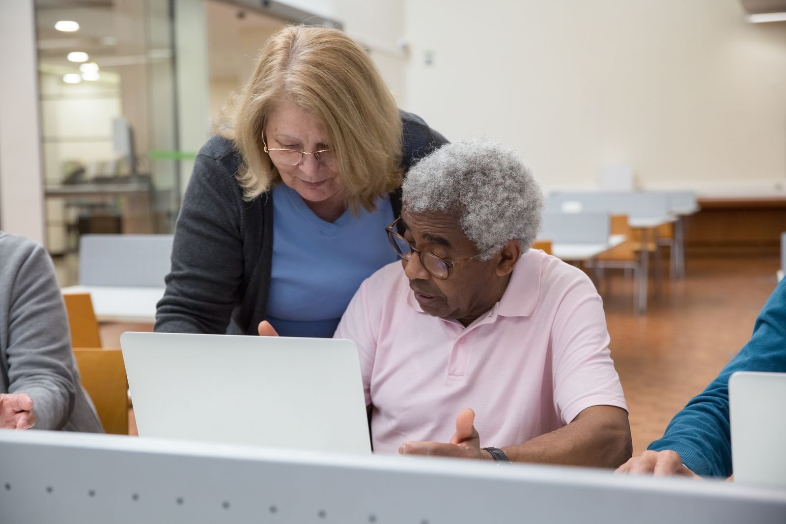Adult learners working together at computers